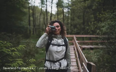 Eine Fotografinauf dem Steg der Ebbemoore